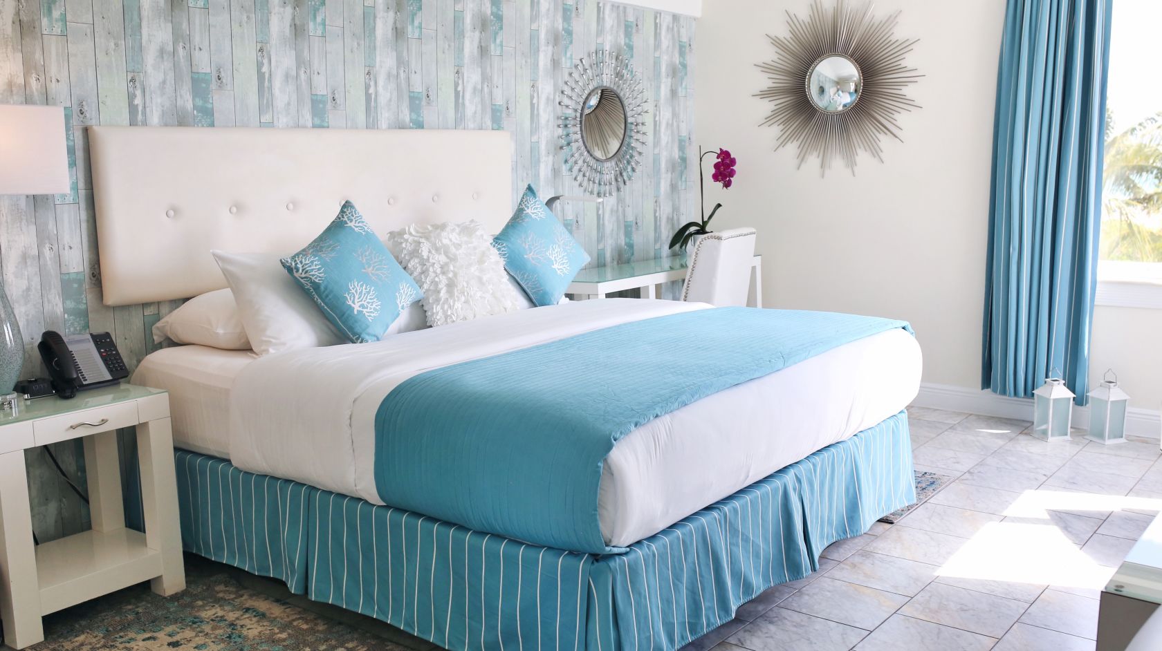 A Blue And White Bed In A Room